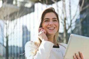 Contact form woman in white blazer holding tablet computer